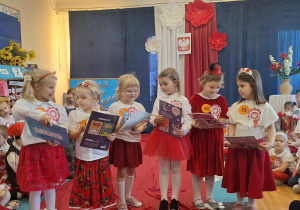 Dzieci oglądają otrzymane nagrody.