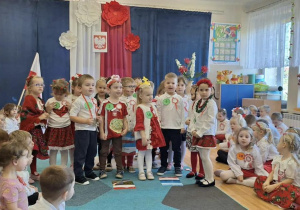 Grupa dzieci w biało-czerwonych strojach.